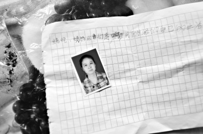 作别字条上的登记照为邢海鹰,右边为女儿小甜甜。 黄师师 摄 作别字条上的登记照为邢海鹰,右边为女儿小甜甜。 黄师师 摄