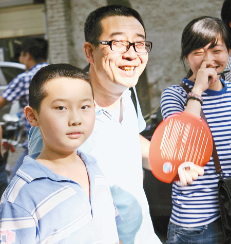 王泽城完成第一天考试,父亲满面笑容接他回家。 记者 张波 摄 王泽城完成第一天考试,父亲满面笑容接他回家。 记者 张波 摄