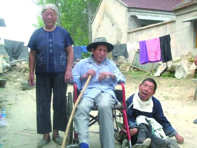 刘桂英和瘫痪的丈夫、儿子在一起。