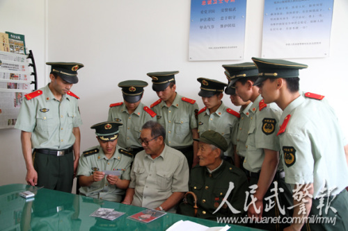 观看珍贵的照片。图片来源:人民武警报 观看珍贵的照片。图片来源:人民武警报
