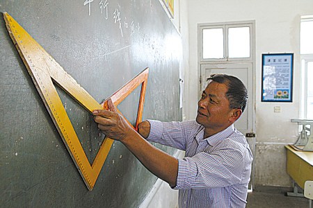 龚金川用残肢抵住三角尺,在黑板上画平行线 龚金川用残肢抵住三角尺,在黑板上画平行线