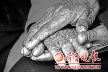 张继友老人紧紧握着老伴的手。 张继友老人紧紧握着老伴的手。