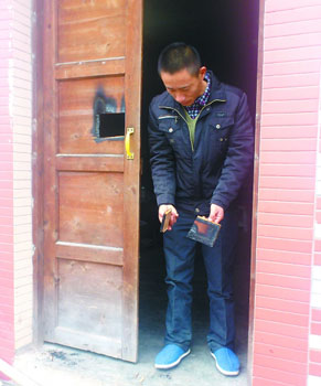 自家木门烧穿一个洞,市民王先生很无奈。记者 徐庶 摄 自家木门烧穿一个洞,市民王先生很无奈。记者 徐庶 摄
