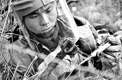 春节期间执行任务的扫雷兵吴昭年正在排除一枚未爆物。 李 强摄 春节期间执行任务的扫雷兵吴昭年正在排除一枚未爆物。 李 强摄