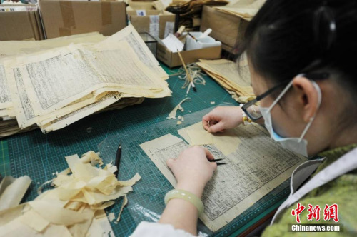 2月底,在甘肃省古籍保护中心里,七八名修复技师正聚精会神地对一页页残破不全的古籍进行精心修复,所经手的每一页纸张至少都有百年以上的历史,这让他们不敢有丝毫的马虎。修复师们熟练细致地完成每一道修复程序,用双手小心翼翼的复原出残卷中的文明记忆,每人每天最多能修复十余页残破古籍。杨艳敏 摄 2月底,在甘肃省古籍保护中心里,七八名修复技师正聚精会神地对一页页残破不全的古籍进行精心修复,所经手的每一页纸张至少都有百年以上的历史,这让他们不敢有丝毫的马虎。修复师们熟练细致地完成每一道修复程序,用双手小心翼翼的复原出残卷中的文明记忆,每人每天最多能修复十余页残破古籍。杨艳敏 摄
