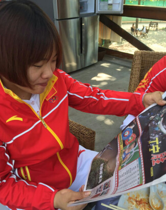 举重冠军向艳梅阅读《奥运快报》。(图片来源:南美侨报网) 举重冠军向艳梅阅读《奥运快报》。(图片来源:南美侨报网)