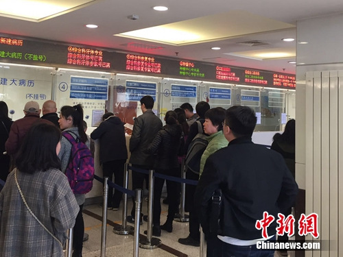 图为市民在北京大学口腔医学院大厅排队挂号。吕春荣 摄 图为市民在北京大学口腔医学院大厅排队挂号。吕春荣 摄