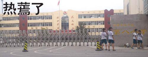 在菏泽,21日最高温达37℃,牡丹区第八小学20多名学生中暑。当地多所小学停课。下图为第八小学停课,大门紧锁。本报记者 邓兴宇 摄
